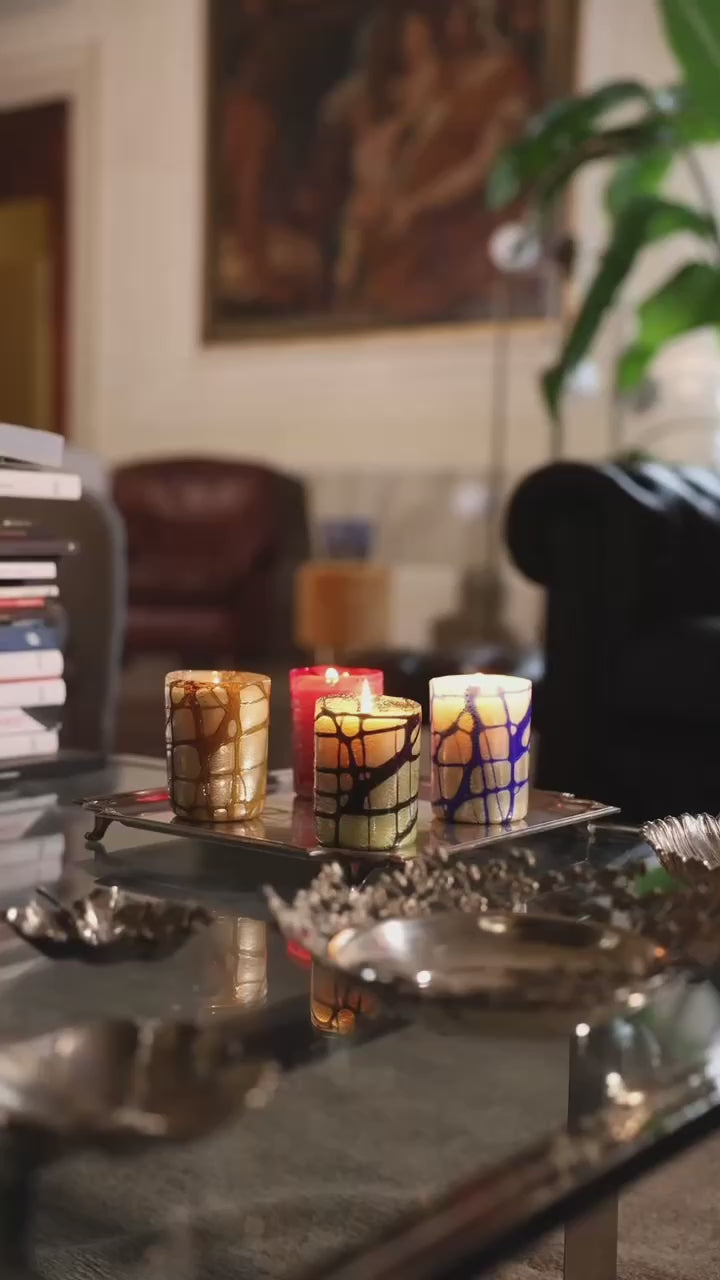 Elegant lady wearing Gucci walking behind a silver tray with hand-blown glass candles made in Venice
